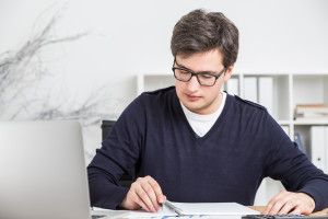 Young businessman doing paperwork